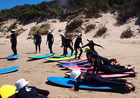 boys and girls surfing