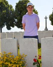 Year 9, stands behind the gravestone of Dr Maldwyn Leslie Williams (OM 1903) 